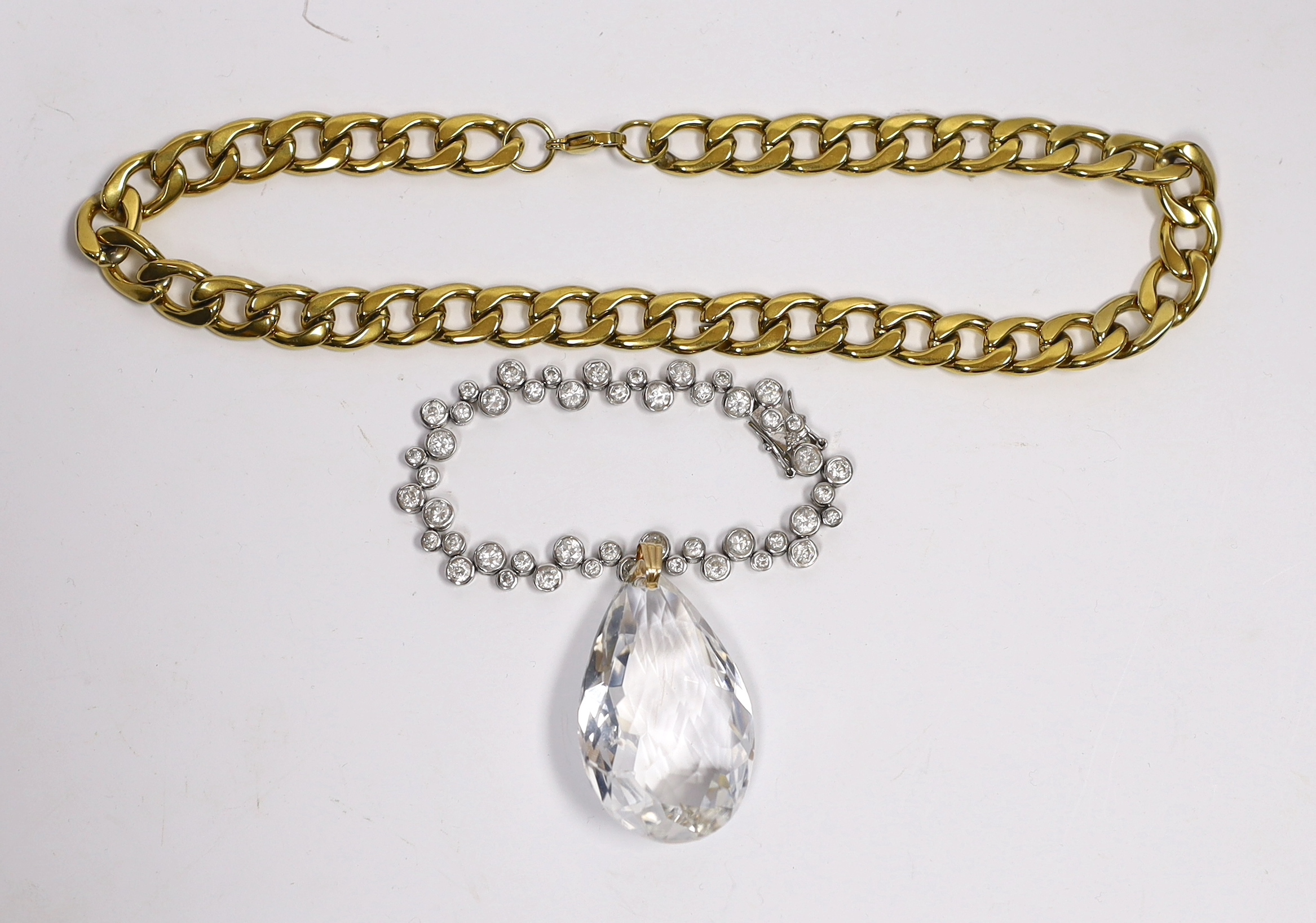 A gilt metal curblink necklace, a white metal paste set bracelet stamped 925 and a rock crystal pendant with gilt metal loop